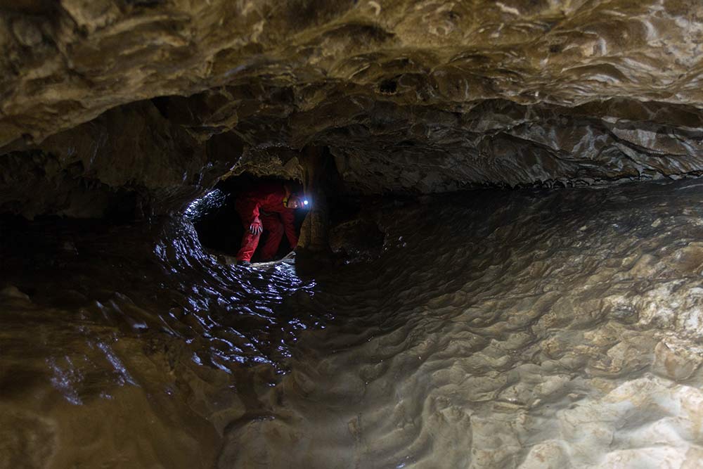 homme dans passage étroit spéléologie annecy